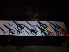 A shelf of assorted scissors.