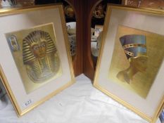 A framed and glazed print of Tut-ankh-amun and another of Nefertiti.