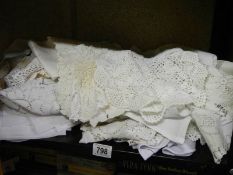A shelf of assorted linen and lace.