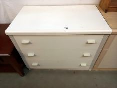 A white melamine bedroom chest of drawers