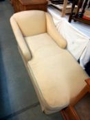 A cream fabric covered day bed chaise longue