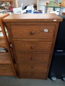 A medium oak chest of drawers, 62cm x 34cm x 123cm