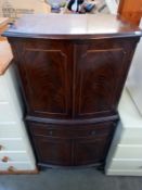A dark wood stained 4 door cabinet with drawer & writing shelf, 61cm x 43cm x 130cm high