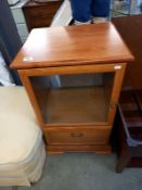 An oak music centre cabinet with drawer