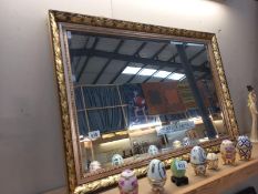 A gilt framed, bevel edge mirror. 61cm x 87cm