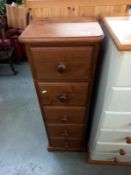 A dark stained solid pine narrow chest of drawers, 38cm x 33cm x 113cm