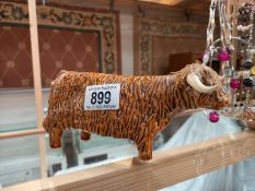 A signed pottery Highland cattle ornament