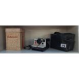 A vintage instant Polaroid 1000 hand camera & a empty Rollicord camera box