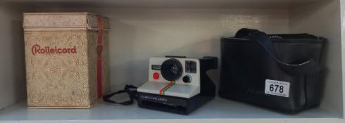 A vintage instant Polaroid 1000 hand camera & a empty Rollicord camera box