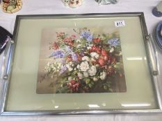 A vintage serving tray with floral print by Vernon Ward in centre under glass