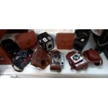 5 cased vintage cameras