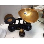A cast iron Salter kitchen scales with weights and brass pan