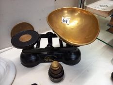 A cast iron Salter kitchen scales with weights and brass pan