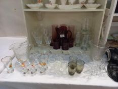 A mixed lot of water jugs & glasses