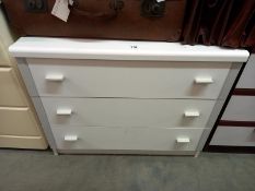 A white melamine bedroom chest of drawers