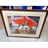 A framed print of dogs under an umbrella