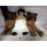 Two vintage teddy bears and a doll.