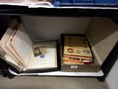 A shelf of old photos and ephemera.