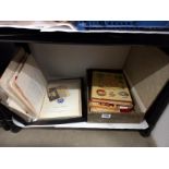 A shelf of old photos and ephemera.