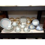 A shelf of tea ware including Doulton.