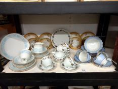 A shelf of tea ware including Doulton.