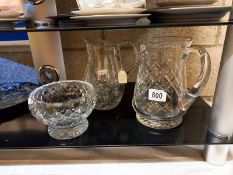 Two cut glass jugs and a cut glass bowl.