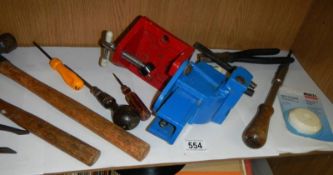 A shelf of small tools and a bench vice.