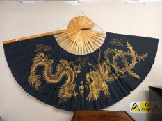 A large ornamental wall fan decorated with dragons