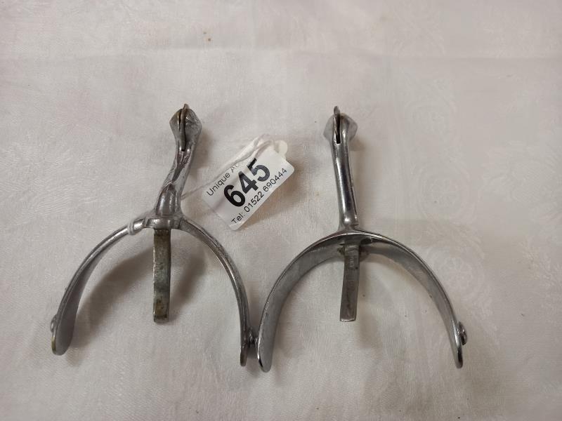 A pair of vintage chrome plated riding spurs.