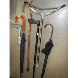 A quantity of walking sticks, shooting stick etc.,