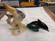 A Poole dolphin and a Jema Holland 1950's pair of angel fish ornament with sticker.
