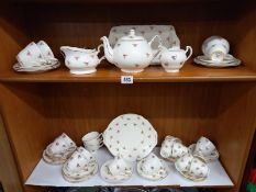 A mixed lot of tea sets of same/similar designs (2 shelves)