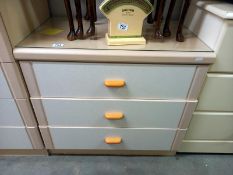 A clean cream bedroom chest of drawers