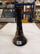 An 11" high Longpark vase with a wide base and narrower neck. Applied flowers and leaves on a