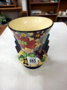 A vase with 2 shoulders, cream inside with painted flowers and leaves outside, numbers and