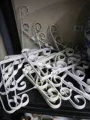 A quantity of new and used scrolly metal shelf brackets.