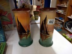 A pair of pottery vases decorated with sailing ships (20cm high)
