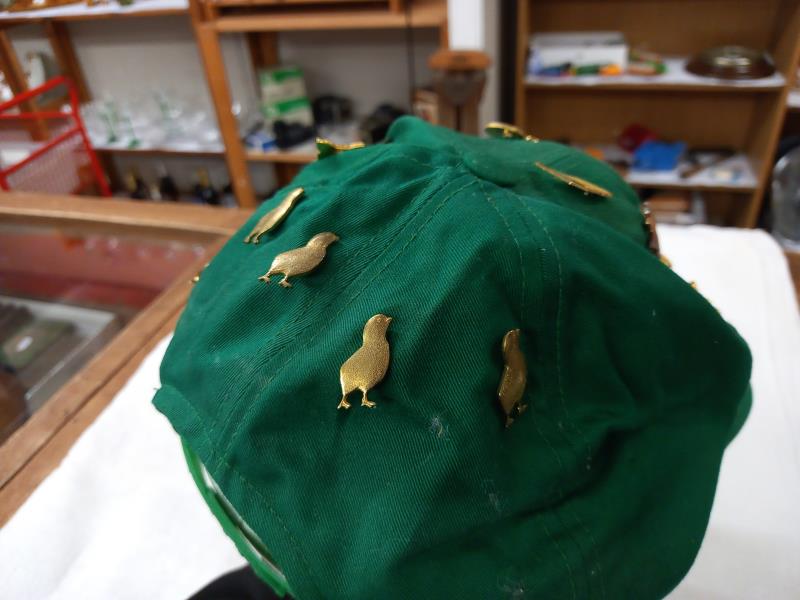 A quantity of badges on a cap. - Image 4 of 4