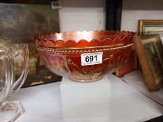 A large carnival glass bowl decorated with relief storks, 24 cm diameter.