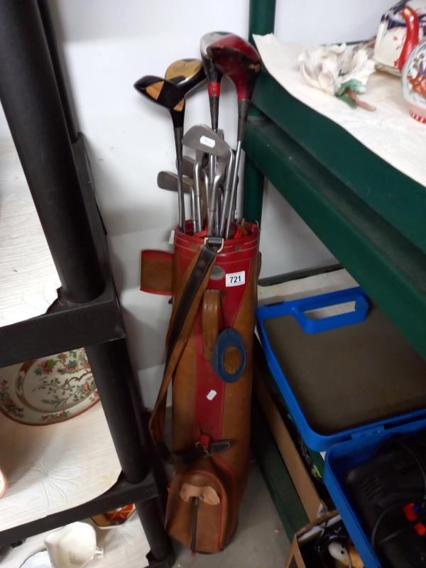 A vintage golf bag and clubs,