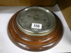 A circular oak 20th century barometer.