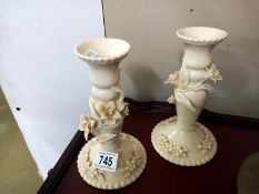 A pair of regal porcelain candlesticks