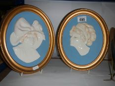 A pair of oval plaster portrait plaques.