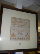 An oak framed and glazed 1914 sampler.