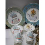 Two commemorative plates and two cups and saucers.