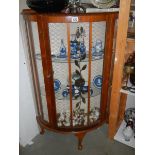 A mid 20th century bow front single door display cabinet. COLLECT ONLY.