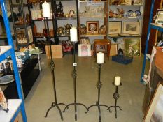 A set of four graduated metal candle holders, COLLECT ONLY