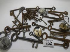 A mixed lot of old keys including padlock with key.