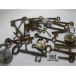 A mixed lot of old keys including padlock with key.