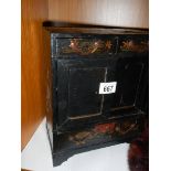 A small lacquered jewellery cabinet.